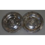 A pair of Elizabeth II hallmarked silver dishes inset with a coin, gross weight 8 1/3oz.