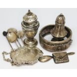 Assorted hallmarked silver comprising a stamp case, two pepperettes, a port decanter label, four