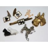 Vintage dog jewellery comprising three brooches, a pendant a bar brooch and a pair of cufflinks.