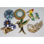 A group of six vintage brooches, floral and birds, and a kingfisher pin badge.