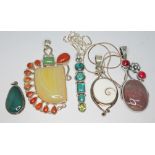 A group of five contemporary crafts pendants, various stones including operculum, turquoise,