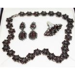 A suite of garnet and pyrite set jewellery comprising necklace, pair of earrings and a ring, all