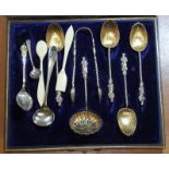 A cased set of hallmarked silver gilt apostle spoons and tongs (one spoon missing), an Ellerman Line