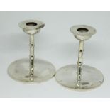 A pair of hallmarked silver candlesticks, height 6.5cm, weight 3oz.