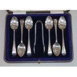 A cased set of six hallmarked silver teaspoons with matching sugar tongs.