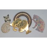 A group of three vintage cat brooches.