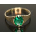 A 9ct gold ring set with green foiled back paste, marked '9ct', gross weight 1.59g, size P.