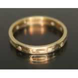 An eternity ring set with colourless stones, marked '9ct', gross weight 1.70g, size N.