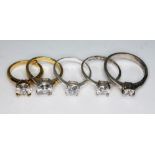 A group of five solitaire rings, four marked '925', sizes J to V.