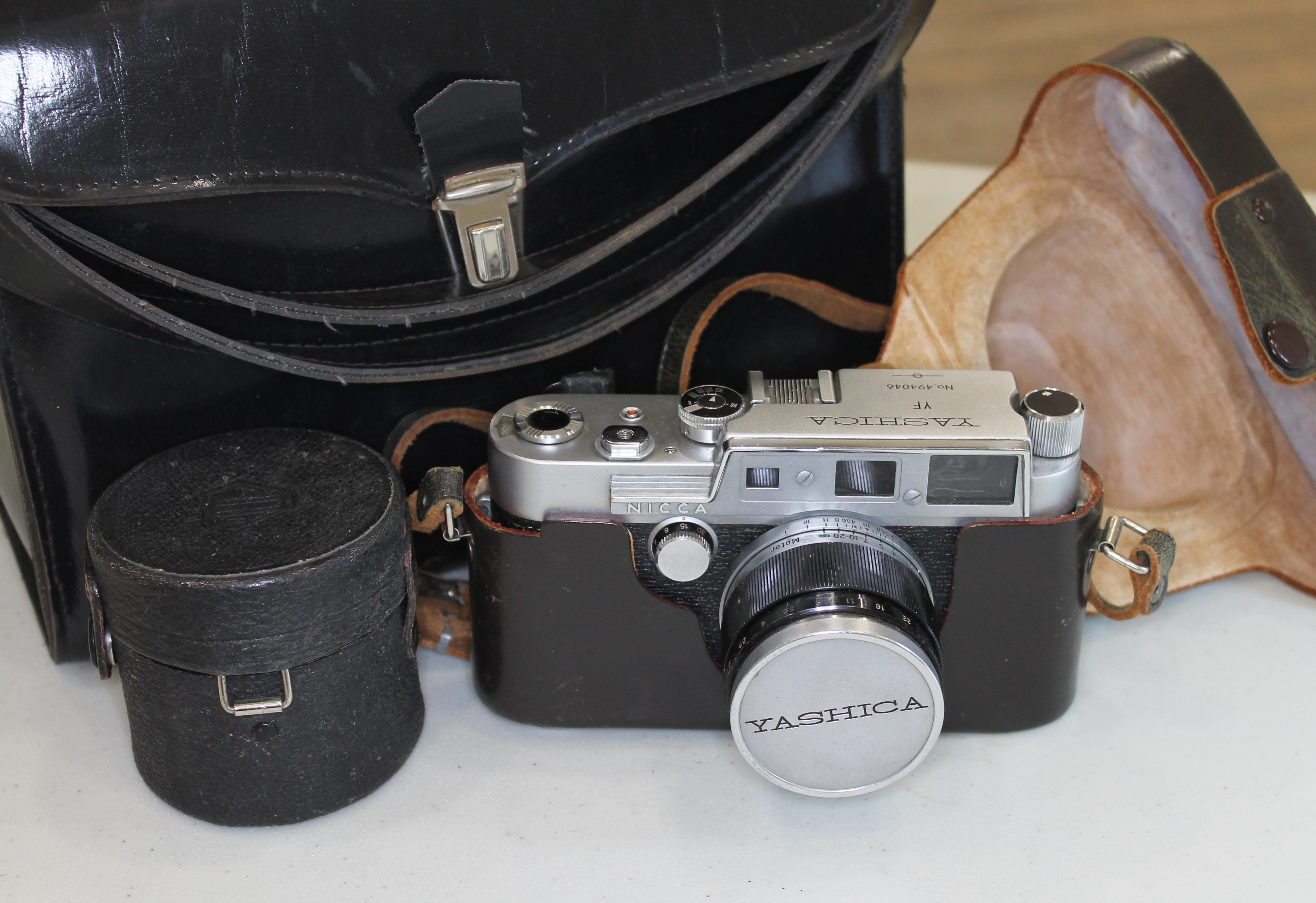 A Yashica YF 35mm rangefinder camera with three lenses.