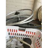 Two pairs of bicycle wheels and basket of spare parts