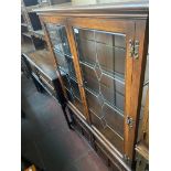 An Old Charm oak and leaded glass side cabinet.