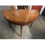 A mahogany demi-lune fold top tea table.