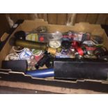 A box containing items of fishing tackle including spools of line, forceps, scissors, spare