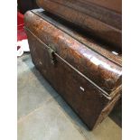 A large metal trunk and contents to include a starburst clock and wicker picnic box etc.