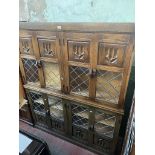 A pair of oak and leaded glass side cabinets.