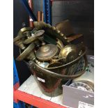 A large brass bucket with contents, mainly metalware.