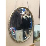 A guilt framed oval mirror