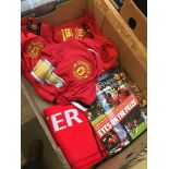 A box of Manchester United memorabilia including 3 shirts, a scarf and programs.