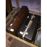 Two vintage cases, one leather.