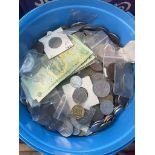 A box of world coins and banknotes.