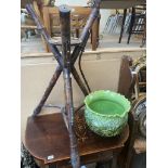 A Victorian bamboo effect jardinier plant stand with green pottery planter decorated with dragons.