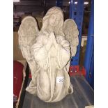 A concrete angel garden ornament