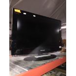 A 26" Samsung TV with remote.
