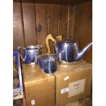 A Picquot ware teapot, cream jug and a sugar bowl