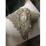 A cherub concrete garden ornament.