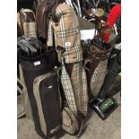 3 golf bags and clubs.