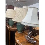 A carved wood table lamp and a pair of crackle glaze green pottery table lamps.