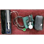 Medical instruments including a stethoscope, a cased opthamalscope and sphygmomanometer.