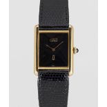 A LARGE SIZE SOLID SILVER GILT MUST DE CARTIER TANK WRIST WATCH DATED 1983, ACCOMPANIED BY