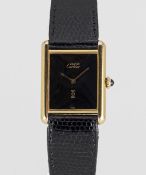 A LARGE SIZE SOLID SILVER GILT MUST DE CARTIER TANK WRIST WATCH DATED 1983, ACCOMPANIED BY