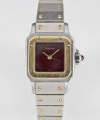 A LADIES STEEL & GOLD CARTIER SANTOS AUTOMATIC BRACELET WATCH CIRCA 1990, WITH BURGUNDY DIAL