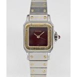 A LADIES STEEL & GOLD CARTIER SANTOS AUTOMATIC BRACELET WATCH CIRCA 1990, WITH BURGUNDY DIAL