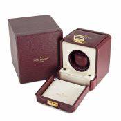 A BURGUNDY LEATHER COVERED PATEK PHILIPPE WATCH WINDER IN ITS ORIGINAL OUTER BOX CIRCA 1990 The