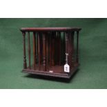 Revolving mahogany bookstand having inlaid top with shaped edge supported on turned and square