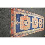 Blue ground rug having red and blue pattern - 46" x 122"