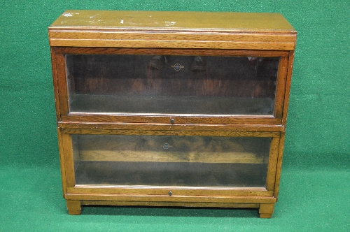 20th century oak two section Globe Wernicke bookcase having glazed up and over doors,