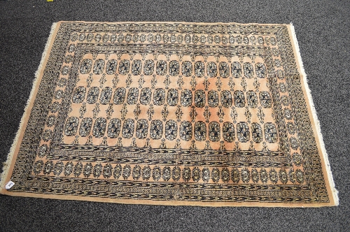 Salmon ground rug having white and black pattern - 51" x 71.