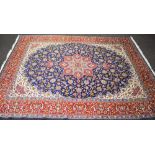 Late 20th century blue ground rug having floral pattern of greens,