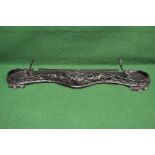 Iron painted fire fender having serpentine front with foliate design and upright fire iron rests -