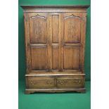 20th century oak Georgian style double wardrobe having dentil cornice over two panelled doors