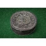 Unmarked white metal filigree box of oval form having enamelled decoration to lid of a flower - 1.