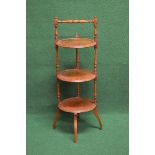 Walnut three tier cake stand having turned top carrying handle over three circular tiers with
