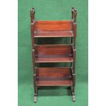 Mahogany three tier book stand having turned finials on block and turned supports leading to 3/4