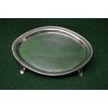 Oval silver tray marked Rossi, Norwich, standing on four swept feet,
