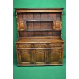 20th century oak dresser the plate rack having two shelves and two panelled cupboard doors,